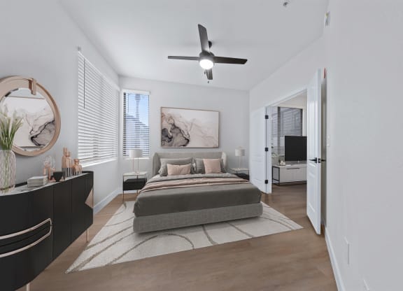 a bedroom with a bed and a ceiling fan